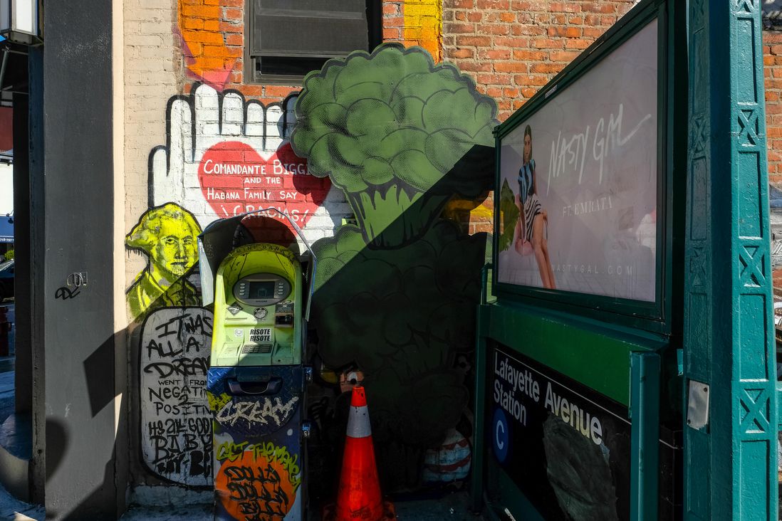 ATM with broccoli street art next to it